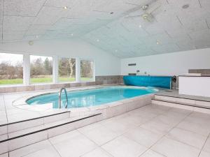 a large swimming pool in a room at 15 person holiday home in Hals-By Traum in Hals