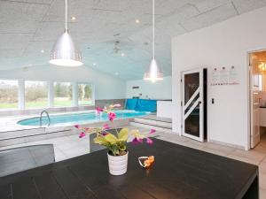 a living room with a swimming pool and a kitchen at 15 person holiday home in Hals-By Traum in Hals