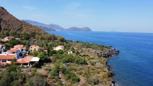 a village on the shore of a body of water at JERA Holiday Collection VULCANO TRE - Sea View in Vulcano