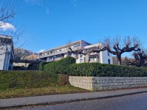 a large white building with trees in front of it at Apartment Altmünster mit Traunsteinblick in Altmünster