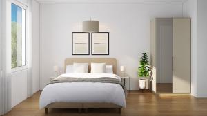 a white bedroom with a bed and a mirror at The R Apartment Belchen in Basel