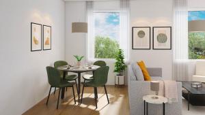 a living room with a table and green chairs at The R Apartment Belchen in Basel