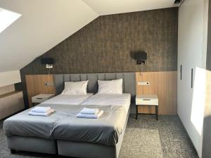a bedroom with a bed with two towels on it at Horizonte Krasocin in Krasocin