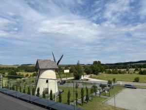 a windmill on the side of a road at Horizonte Krasocin in Krasocin