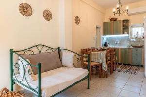 a living room with a couch and a kitchen at Peaceful Refuge In Mani 2 in Kótronas