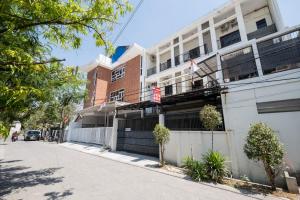 a building on the side of a street at RedDoorz At Graha 99 Simomulyo in Surabaya