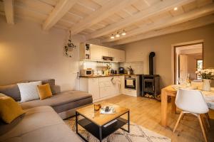 a living room with a couch and a table at D9 Cottage in Csesznek