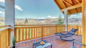 a porch with chairs and a table on a wooden deck at Przy Starej Piekarni Dream Apart in Szklarska Poręba