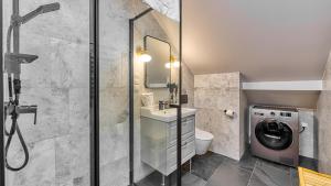 a bathroom with a sink and a washing machine at Przy Starej Piekarni Dream Apart in Szklarska Poręba +17 photos