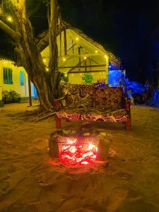 阿鲁甘湾Marina Village的晚上，一张沙发坐在一棵树前