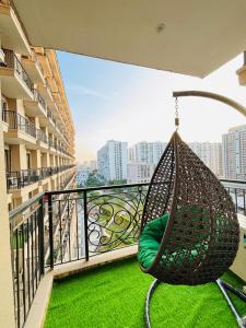 a hammock on the balcony of a building at Zoneout Stays Omaxe Hazratganj in Lucknow