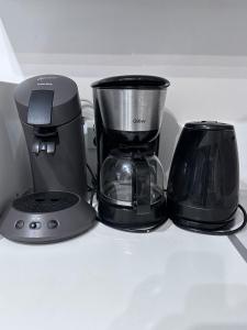 a coffee maker and a blender on a shelf at Le Cocon Familiale - Disneyland paris in Chessy