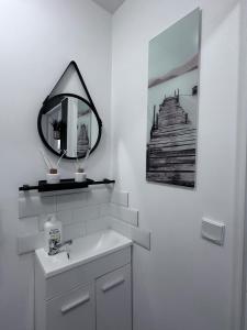 a bathroom with a sink and a mirror on the wall at Le Cocon Familiale - Disneyland paris in Chessy