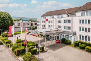 an overhead view of a building with red flags at Leonardo Hotel Aachen in Aachen
