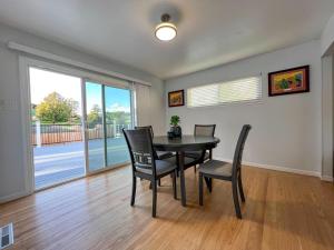 a dining room with a table and chairs and a window at Malcolm Commons in Oakland