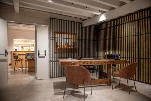 a room with a wooden table and chairs at Hotel Casa W in Venice