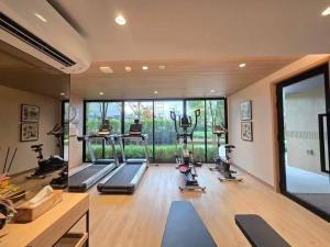 a gym with treadmills and exercise machines in a room at One bedroom apartment 702 in Pattaya city center in Pattaya North