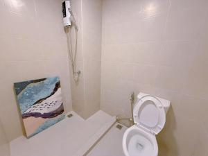 a bathroom with a toilet and a painting on the wall at One bedroom apartment 702 in Pattaya city center in Pattaya North +14 photos