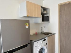 a small kitchen with a washing machine and a sink at One bedroom apartment 702 in Pattaya city center in Pattaya North