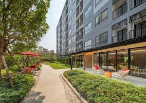 an apartment building with chairs and a patio at One bedroom apartment 702 in Pattaya city center in Pattaya North