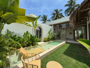 a house with a swimming pool in the yard at Baiana Beach Villas in General Luna