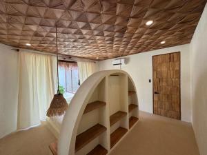 a room with a staircase and a wooden ceiling at Baiana Beach Villas in General Luna