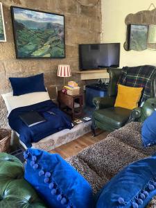 a living room with a couch and a tv at Daffodil in Whitby