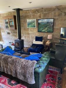 a living room with a couch and a fireplace at Daffodil in Whitby +2 photos