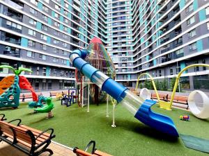 a playground in front of a large apartment building at Oasis Residence Luxury Apartament in Chişinău