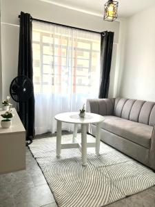 a living room with a couch and a table at Happy Valley Homes in Kisumu