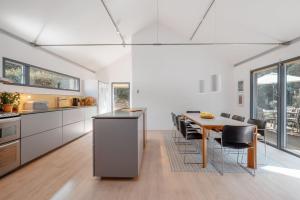 a kitchen and dining room with a table and chairs at Underhill in Corfe Castle
