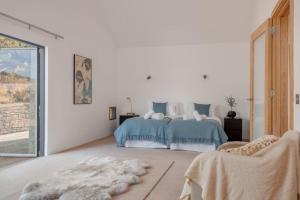 a bedroom with a bed with blue and white sheets at Underhill in Corfe Castle