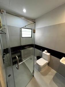 a bathroom with a shower and a toilet and a sink at Heart of Phrom Phong in Khlong Toei +6 photos