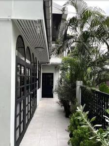 a hallway leading to a building with a black door at Heart of Phrom Phong in Khlong Toei
