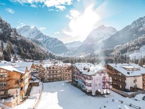 a town in the mountains in the snow at B&B Cèsa Planber Mountain View SKI-IN SKI-OUT in Canazei +165 photos
