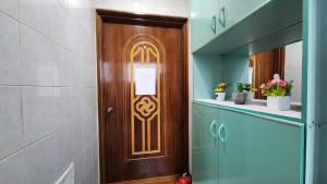 a wooden door with a sign on it in a hallway at 반월당 스테이션 #1 in Daegu
