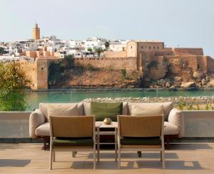 a living room with a couch and two chairs at Fairmont Residences La Marina Rabat Sale in Rabat