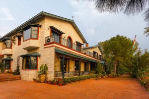a large brick house with a balcony on top of it at Mistair 5BR Private Villa Cook Staff Pool Table in Kasauli