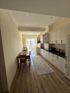 a kitchen with a table and a dining room at CenterApart in Bishkek