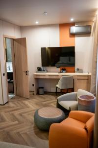 a living room with a desk and a couch and a chair at Ala Boutique Hotel in Almaty