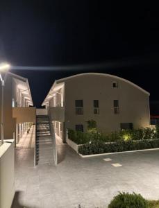 a building with a staircase in front of it at night at Casa Quetta in Bari