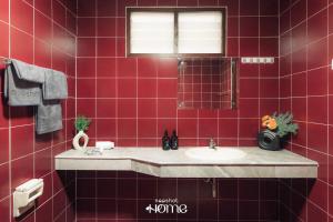 a red tiled bathroom with a sink and a mirror at Life in Phrom Phong in Khlong Toei +22 photos