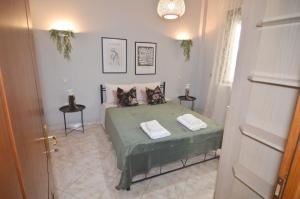 a bedroom with a bed with two towels on it at Panagiotis Suite in Kastoria