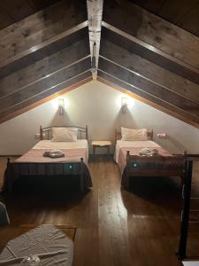 a room with two beds in a attic at The stone Mansion of 1887  +75 photos