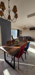 a dining room table with chairs and a chandelier at Cozy&bright apartment Kotor in Kotor
