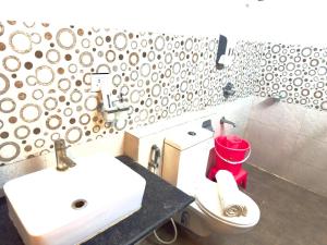 une salle de bain avec un lavabo blanc et des toilettes dans l'établissement Hotel Fortune Home E-46 Noida Sector 72, à Noida
