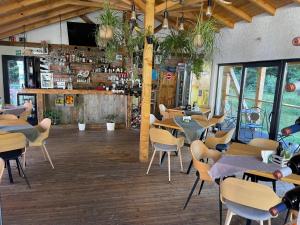 a restaurant with tables and chairs and a bar at Anelisse Inn in Moieciu de Sus