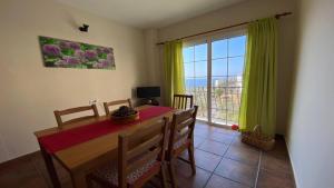 a dining room with a table and a large window at Gran Rey n4 in Valle Gran Rey