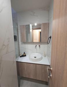 a bathroom with a sink and a mirror at Kos central vibes - Casa Vasilis in Kos
