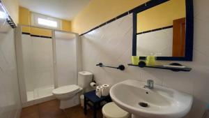 a bathroom with a sink and a toilet and a mirror at Gran Rey n4 in Valle Gran Rey